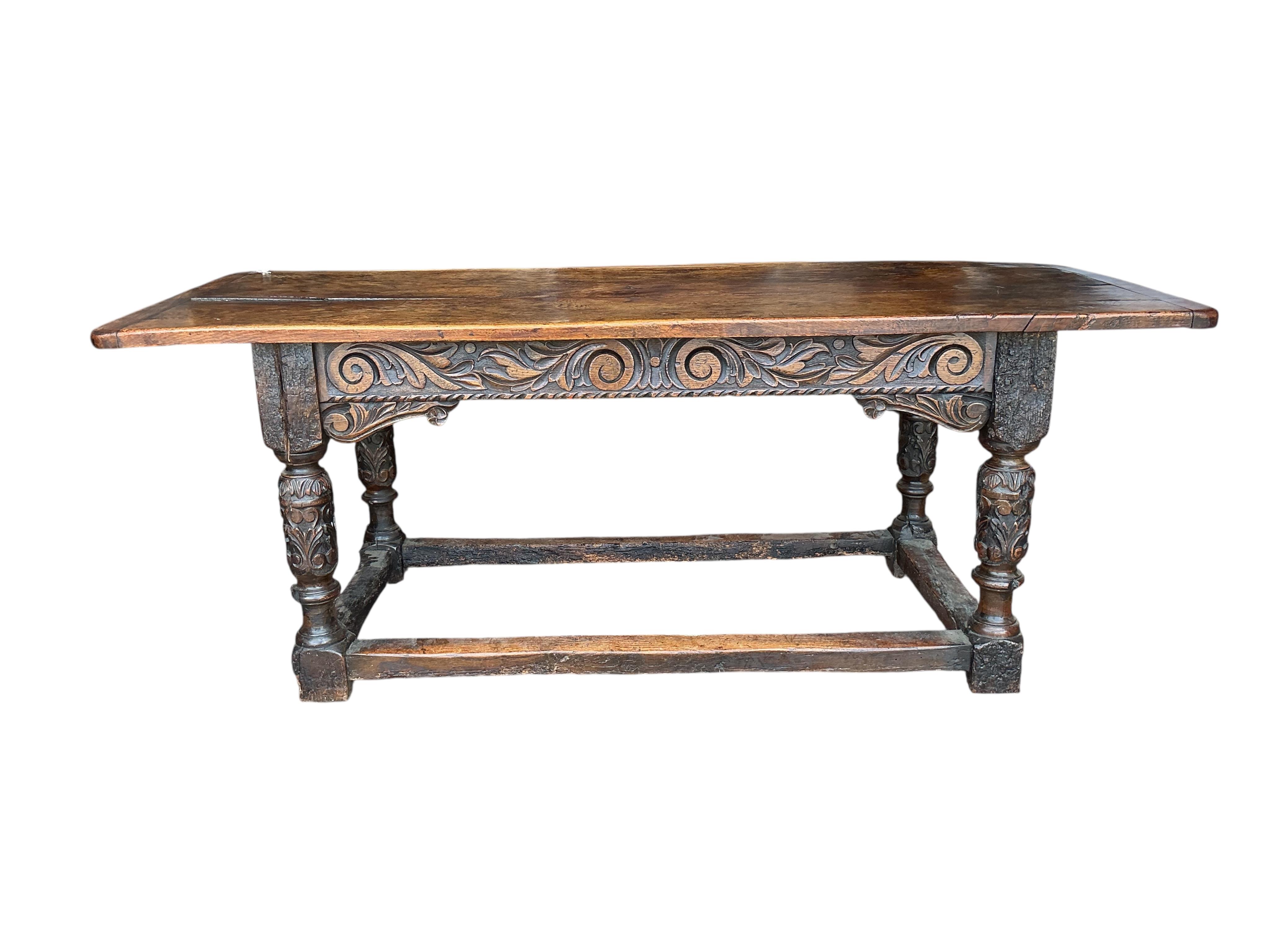 A 17th century style carved oak rectangular refectory table, incorporates old timber, width 198cm, depth 75cm, height 76cm
